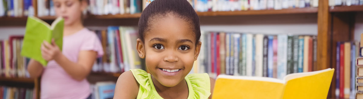 involved_header Girl reading a book and smiling